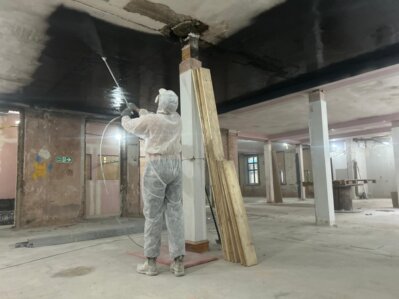 Close-up of lining paper being smoothed onto a prepared wall