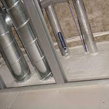 Installer applying ablative-coated fire batt around services